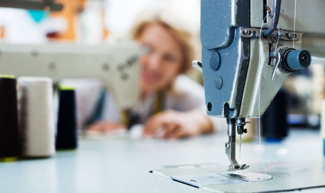 Una dona treballa en una fàbrica de teixits | Shutterstock