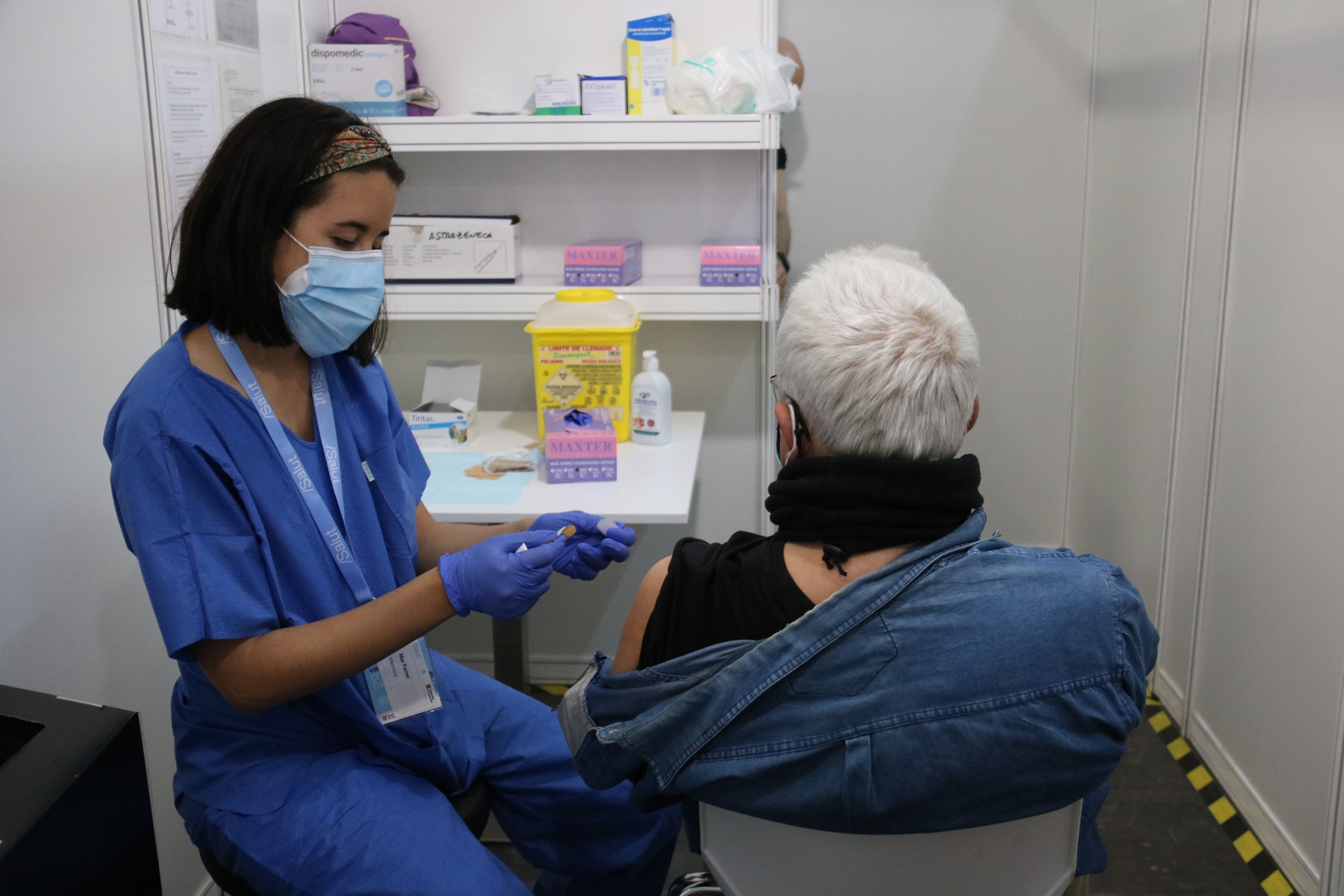 Una sanitària vacuna una persona a la Fira de Montjuïc aquest 26 d'abril | ACN Una sanitària vacuna una persona a la Fira de Montjuïc aquest 26 d'abril | ACN