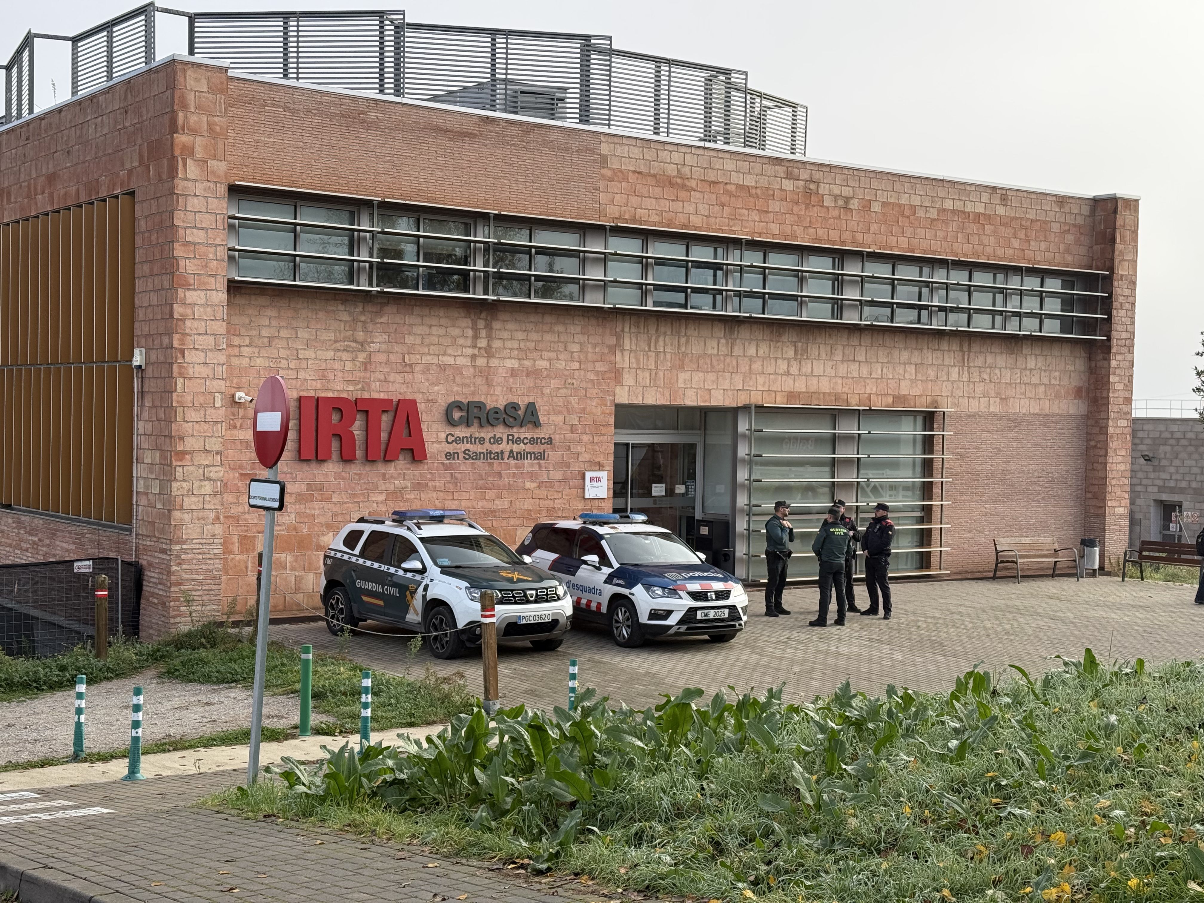 Agentes de los Mossos y de la Guardia Civil en el exterior del IRTA-CReSA | Àlex Recolons (ACN)