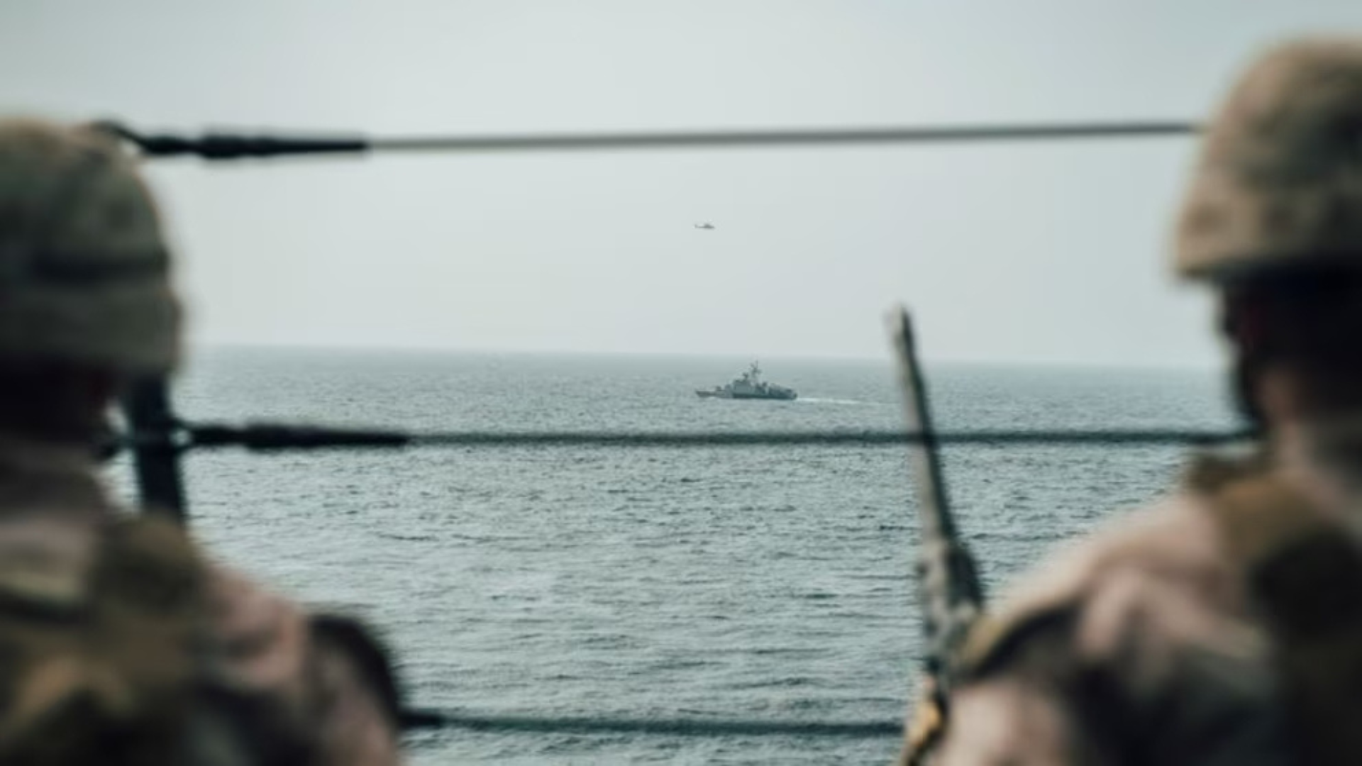 Miembros de la Infantería de Marina de EEUU observan una llança rápida de ataque iraní desde el buque USS 'John P. Murtha', durante un recorrido por el estrecho de Ormuz | US Navy (Reuters)
